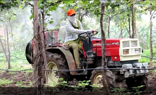 Jyotsna Daund, working in her farm with a tractor.